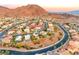 Wide aerial shot of the neighborhood showcasing lush greenery and mountain views at 784 Tossa De Mar Ave, Henderson, NV 89002