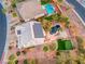 Aerial view of home featuring solar panels, pool, putting green, and covered patio at 784 Tossa De Mar Ave, Henderson, NV 89002