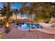 Backyard featuring a free form pool, desert landscaping, and mountain views at 784 Tossa De Mar Ave, Henderson, NV 89002
