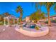 Backyard with a custom pool, mature palm trees, a covered patio, and desert landscaping at 784 Tossa De Mar Ave, Henderson, NV 89002