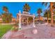 Outdoor space featuring a charming pergola, an outdoor dining area, and desert landscaping at 784 Tossa De Mar Ave, Henderson, NV 89002