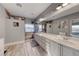Elegant bathroom featuring a dual sink vanity, a walk-in shower, and light wood flooring with ample natural light at 784 Tossa De Mar Ave, Henderson, NV 89002