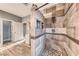 Stylish walk-in shower in the bathroom featuring modern tile and wood-look flooring with neutral gray paint at 784 Tossa De Mar Ave, Henderson, NV 89002