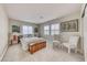 Bright bedroom featuring neutral walls, large windows, and comfortable seating, creating a serene atmosphere at 784 Tossa De Mar Ave, Henderson, NV 89002