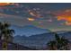 Scenic view from a rooftop captures the beauty of the mountains and the colorful, expansive sky above the cityscape at 784 Tossa De Mar Ave, Henderson, NV 89002