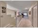 Upstairs hallway leading to the living space with neutral carpet, white railings, and natural lighting at 784 Tossa De Mar Ave, Henderson, NV 89002