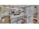 Bright kitchen features a granite island, stainless steel appliances, and white cabinetry at 784 Tossa De Mar Ave, Henderson, NV 89002