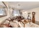 Cozy living room with plush seating, a decorative mirror, and warm lighting fixtures at 784 Tossa De Mar Ave, Henderson, NV 89002