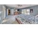 Large primary bedroom featuring plush carpet, blue accent walls, an ensuite bath, and ample natural light at 784 Tossa De Mar Ave, Henderson, NV 89002