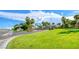 Well-maintained street view showcasing the lush greenery, mature trees, and inviting entrance of the Palm Hills community at 784 Tossa De Mar Ave, Henderson, NV 89002