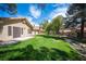 Well-maintained backyard featuring a lush lawn, stream, and mature trees at 7913 Sailboat Ln, Las Vegas, NV 89145