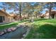 Beautiful landscaping in backyard with water feature, grass and mature trees at 7913 Sailboat Ln, Las Vegas, NV 89145
