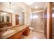 This bathroom features a granite vanity, frameless shower, toilet, and tile flooring at 7913 Sailboat Ln, Las Vegas, NV 89145