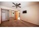This bedroom features neutral walls and carpet, closet with mirrored doors, and a ceiling fan with light at 7913 Sailboat Ln, Las Vegas, NV 89145