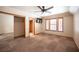 This bedroom features neutral walls and carpet, windows with blinds, and a closet with mirrored doors at 7913 Sailboat Ln, Las Vegas, NV 89145