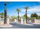 Gated community entrance with mature palm trees and attractive landscaping at 7913 Sailboat Ln, Las Vegas, NV 89145
