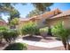 Well-maintained front yard with lush bushes and desert landscaping at 7913 Sailboat Ln, Las Vegas, NV 89145