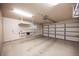 Spacious garage featuring storage, shelving and work bench at 7913 Sailboat Ln, Las Vegas, NV 89145
