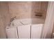 A close up of the white walk-in tub in the bathroom at 7913 Sailboat Ln, Las Vegas, NV 89145