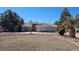 Spacious single-story home with a tile roof, circular driveway, and desert landscaping on a sunny day at 821 W Amarillo Ave, Pahrump, NV 89048