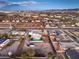 Aerial view showcasing pool, turf, oversized lot, landscaping, neighborhood, and city views at 8645 Edmond St, Las Vegas, NV 89139