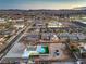 Aerial view showcasing the pool, turf, oversized lot, landscaping, neighborhood, and nearby commerce at 8645 Edmond St, Las Vegas, NV 89139