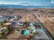Aerial view showcasing pool, oversized lot, landscaping, neighborhood, and city skyline at 8645 Edmond St, Las Vegas, NV 89139