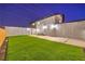 Inviting backyard with manicured artificial turf, a secure fence, and direct access to the home at 8645 Edmond St, Las Vegas, NV 89139