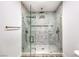 Contemporary walk-in shower featuring gray marbled tile, dual shower heads, and glass enclosure at 8645 Edmond St, Las Vegas, NV 89139