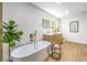 Elegant bathroom featuring a freestanding tub, modern vanity with twin mirrors, and stylish fixtures at 8645 Edmond St, Las Vegas, NV 89139