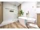 Elegant bathroom featuring a soaking tub, glass-enclosed shower, and stylish fixtures at 8645 Edmond St, Las Vegas, NV 89139