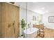 Stylish bathroom featuring a walk-in shower, soaking tub, modern vanity, and elegant gold fixtures at 8645 Edmond St, Las Vegas, NV 89139