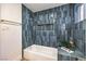 Stylish bathroom with blue tile, white tub, and gold hardware at 8645 Edmond St, Las Vegas, NV 89139