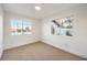 Bright bedroom featuring neutral carpet, white walls, and two windows for natural light at 8645 Edmond St, Las Vegas, NV 89139