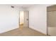 Bedroom with neutral carpet and white walls with walk-in closet and door way at 8645 Edmond St, Las Vegas, NV 89139