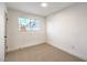 Bright bedroom with neutral carpet, white walls, and a window for natural light at 8645 Edmond St, Las Vegas, NV 89139