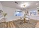 Bright dining area with wood floors, modern lighting, view to the backyard, and view to the kitchen at 8645 Edmond St, Las Vegas, NV 89139