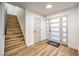 Bright foyer with hardwood floors, staircase, and modern front door at 8645 Edmond St, Las Vegas, NV 89139