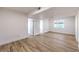 Bright, spacious living area featuring wood-look floors, white walls, and natural light at 8645 Edmond St, Las Vegas, NV 89139