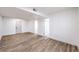 Open concept living room boasts wood-look flooring, white walls, and natural lighting at 8645 Edmond St, Las Vegas, NV 89139