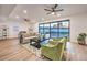 Well-lit living room featuring modern furniture and decor, complemented by a view of the pool through large glass doors at 8645 Edmond St, Las Vegas, NV 89139