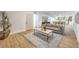 Sunlit living room boasts an open floor plan, wood floors, and modern finishes that create a relaxing atmosphere at 8645 Edmond St, Las Vegas, NV 89139