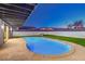 Backyard with a pool and artificial grass with a view of neighboring houses at 8645 Edmond St, Las Vegas, NV 89139