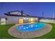 Backyard with pool and view into the living room, surrounded by artificial turf at 8645 Edmond St, Las Vegas, NV 89139