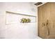 Close-up of a luxurious shower with elegant tile work, a niche for storage, and a rainfall showerhead at 8645 Edmond St, Las Vegas, NV 89139