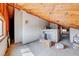Attic space featuring wooden beams, concrete floors, and a window to provide natural lighting at 9010 W Lone Mountain Rd, Las Vegas, NV 89129