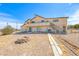 Backyard featuring an extended desert landscape, chain link fence, and patio with stair access at 9010 W Lone Mountain Rd, Las Vegas, NV 89129