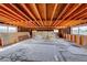 Unfinished basement space with exposed wood beams and abundant natural light from the surrounding windows at 9010 W Lone Mountain Rd, Las Vegas, NV 89129