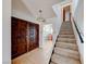 The home's foyer shows tile flooring, wooden doors, staircase and a view into the kitchen at 9010 W Lone Mountain Rd, Las Vegas, NV 89129