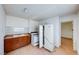 Kitchen with wooden cabinets, tile countertops, white appliances, and a tile backsplash at 9010 W Lone Mountain Rd, Las Vegas, NV 89129